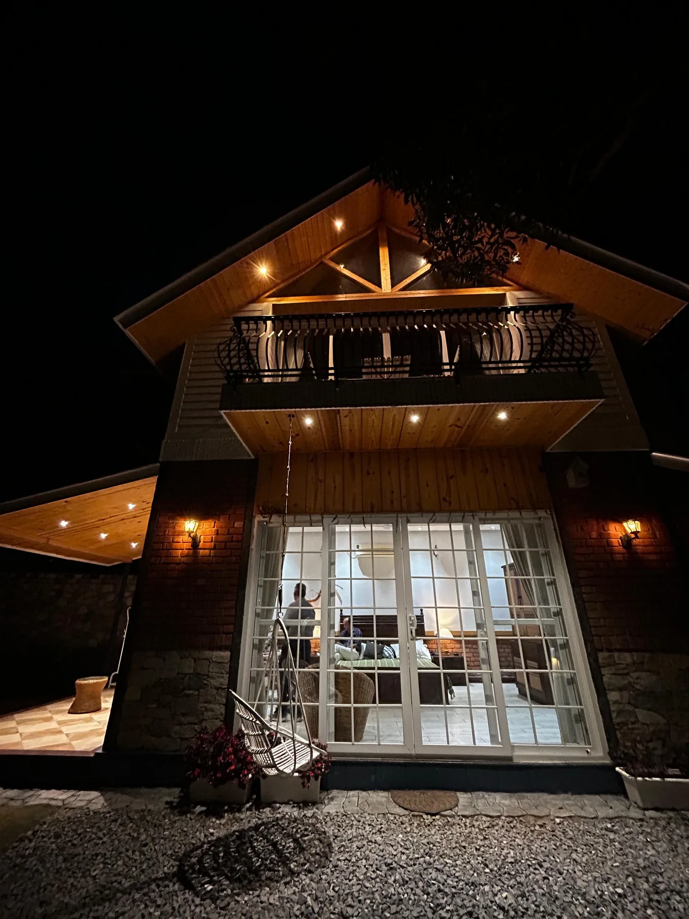 Night view of the Mussoorie residence with illuminated gable roof