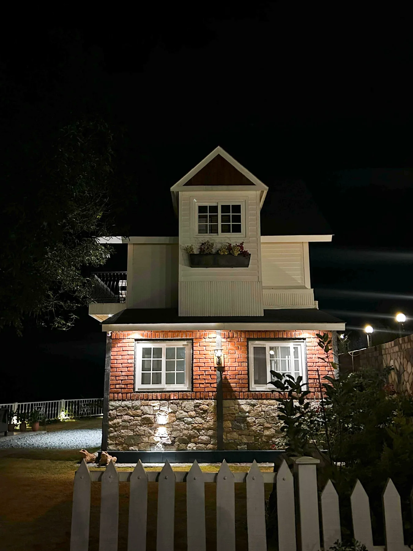 Night view of a cottage volume at the Mussoorie project