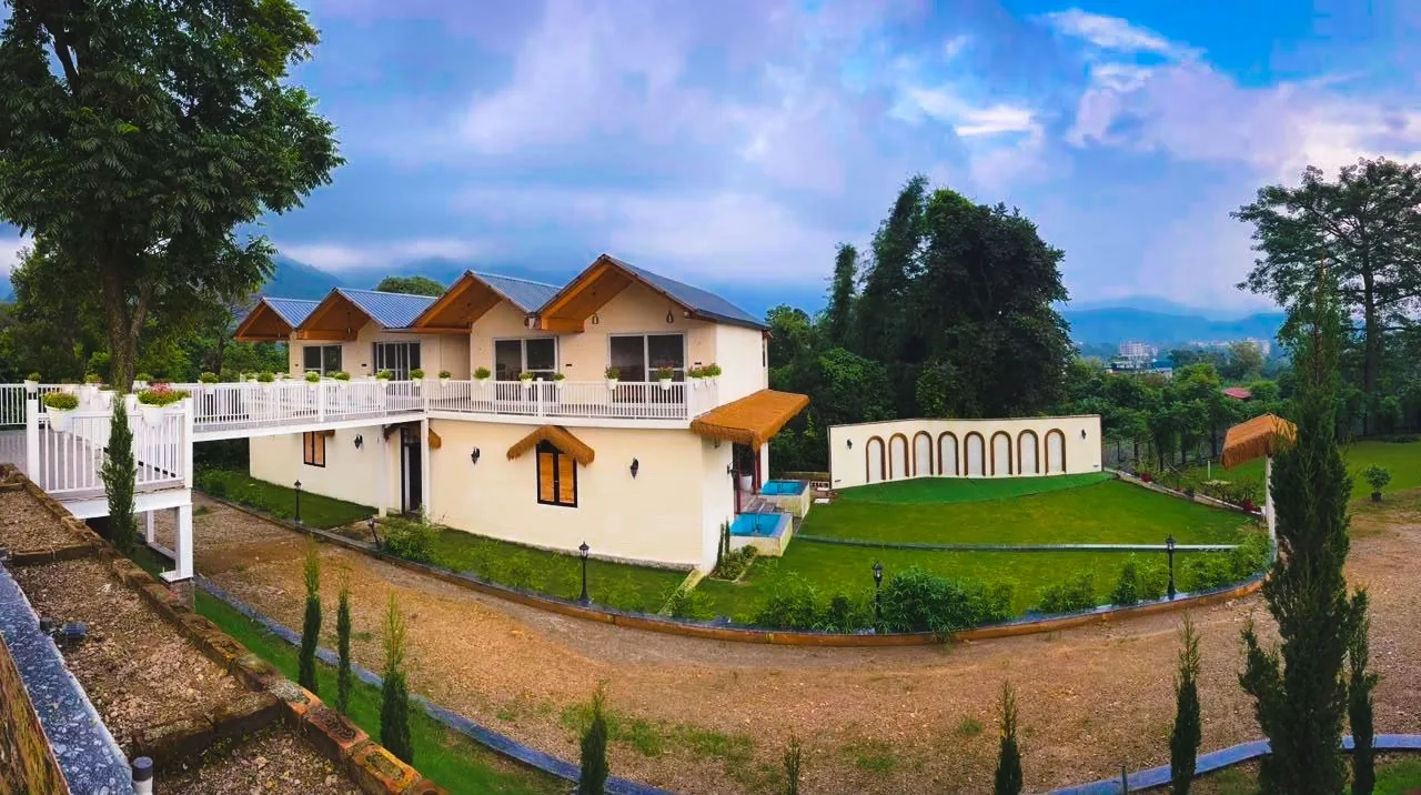 Wide exterior view of the Mussoorie residence and lawn