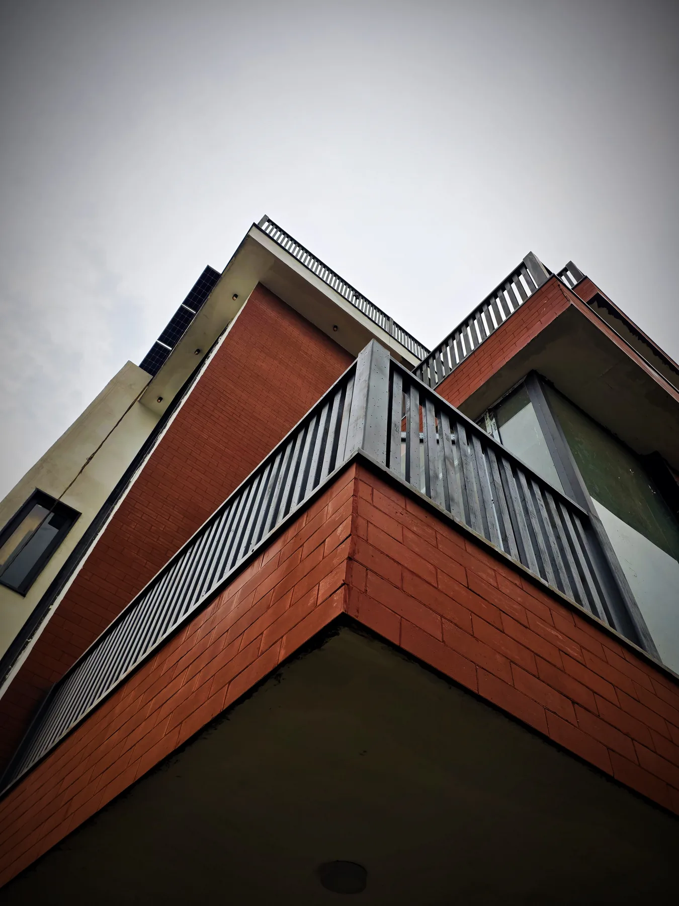 Low-angle view of the brick exterior at Sigma 1 Residence, Greater Noida