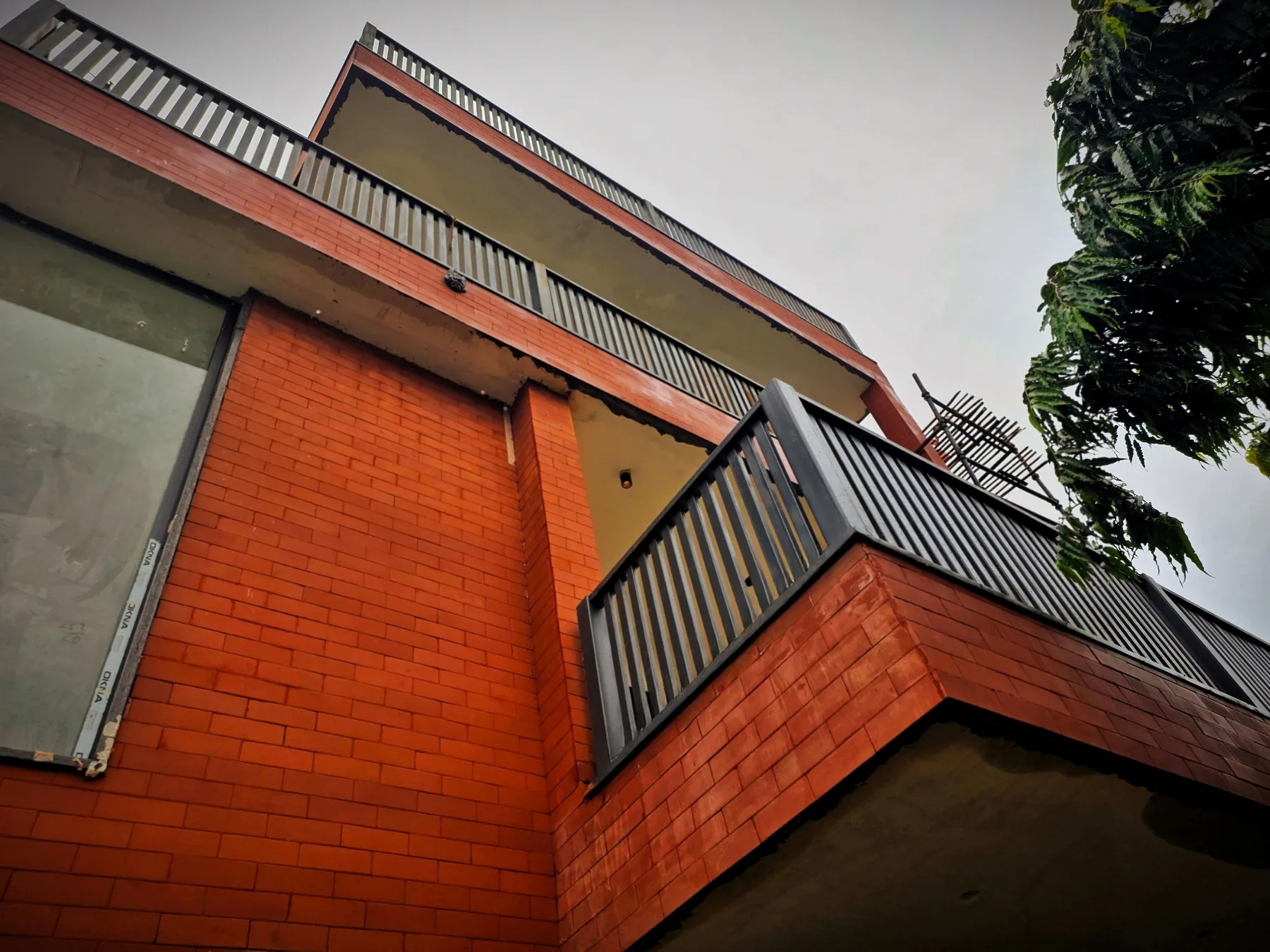 Brick façade and balcony detailing at Sigma 1 Residence, Greater Noida